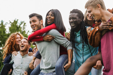 Young diverse friends, having fun outdoor laughing together - Focus on african girl face