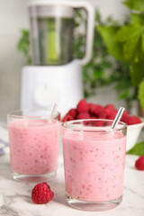 Tasty fresh raspberry smoothie on white marble table