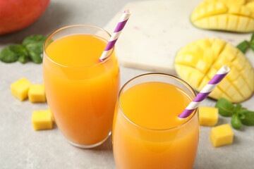 Fresh delicious mango drink on light table