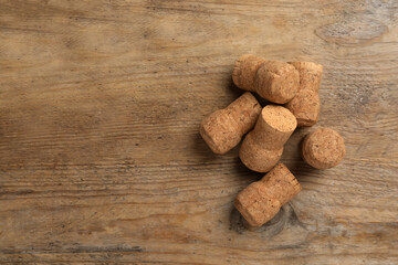 Sparkling wine corks on wooden table, flat lay. Space for text