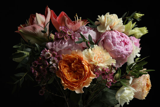 Beautiful bouquet of different flowers on black background