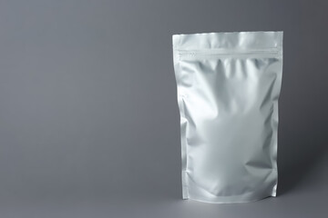 One blank foil package on grey background. Space for text