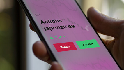 Un investisseur analyse un fonds etf actions japonaises sur un graphique. Un téléphone affiche le cours de l'ETF. Texte en français francais Actions japonaises