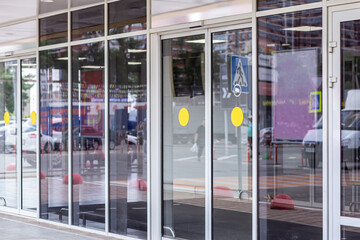 Supermarket automatic glass doors with camera sign closeup