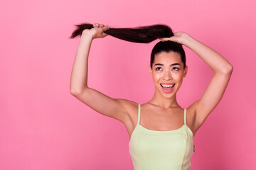 Photo of adorable dreamy girl dressed yellow sarafan looking empty space holding long tail isolated...
