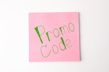 Note with words Promo Code on white background, top view