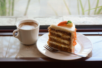 Delicious cake and cup of hot coffee on windowsill indoors