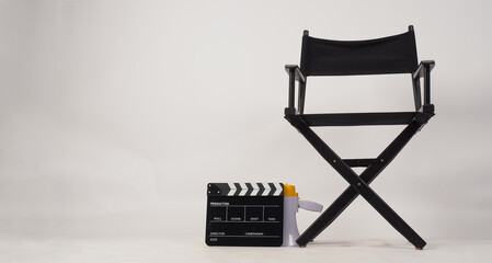 Obraz premium Black director chair and Black Clapper board or movie slate and megaphone on white background..