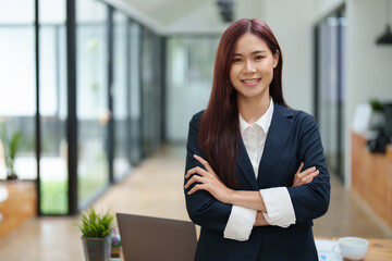 Portrait of a business woman standing with her arms crossed