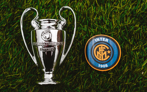 April 21, 2021, Moscow, Russia. The emblem of the football club Inter Milan and the UEFA Champions League cup on the green grass of the stadium.