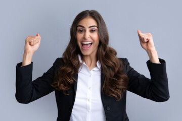 Cheerful beautiful young woman showing winner gesture. Girl celebrating crazy and amazed for...