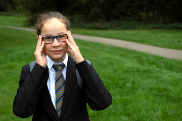 Teen age girl outdoor, wearing formal school uniform, with bagpack