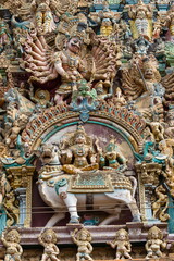 Fototapeta na wymiar Sculpture of Demo, Lord Shiva and Parvati on. Meenakshi Amman Temple Gopuram, Madurai, Tamilnadu, India.