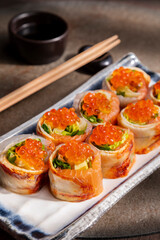 Roll with eel, salmon, red salmon caviar, avocado and salad