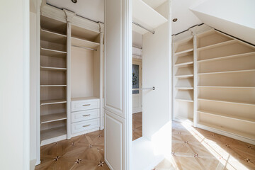 wardrobe room with light furniture, many shelves and places for things