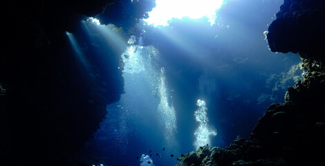 Underwater photo from a scuba dive inside caves and tunnels with rays of light. Beautiful scenery...