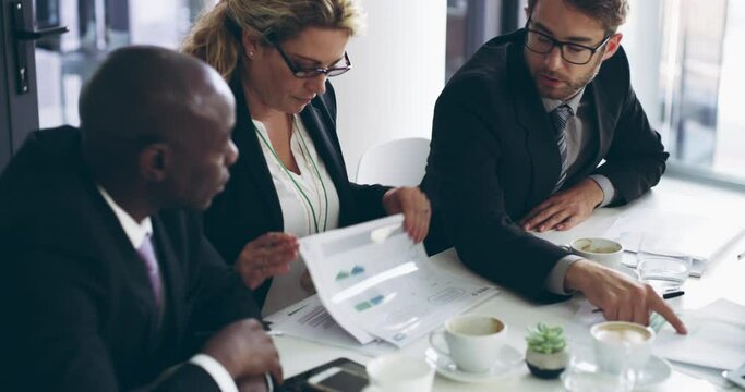 Group of corporate businesspeople having a meeting in the boardroom. Professional financial and diverse team discussing strategy and new ideas inside the office. Executive planning and discussion.