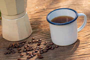 white enamel coffee mug on the old wooden table