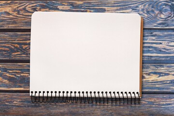 Quote concept with a white notebook page placed on a wooden background.