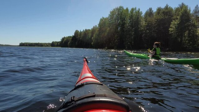 Active young woman paddling on kayak in Sweden. Family Sports. Summer. Travel. Tourism