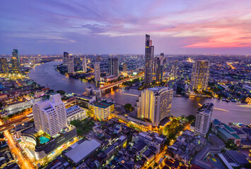 Bangkok river view at sunset with modern business building along the Chao Phraya river ,Thailand