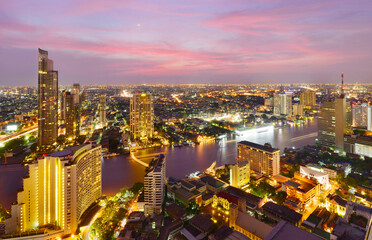 Fototapeta na wymiar Bangkok river view at sunset with modern business building along the Chao Phraya river ,Thailand