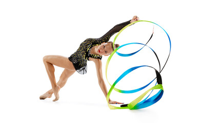 Fototapeta na wymiar Portrait of young, professional female rhythmic gymnast training with colorful ribbons isolated over white studio background.