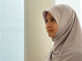 Portrait young woman wearing hijab looking away