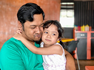 Fototapeta premium Father and daughter enjoying togetherness at a restaurant