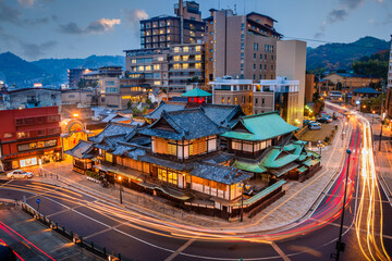 Matsuyama, Japan downtown skyline at Dogo Onsen bath house at twilig - obrazy, fototapety, plakaty