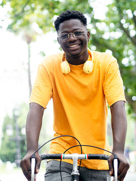  African American young man with a bicycle in the city. Sustainable mobility, millennial lifestyle 