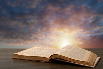 Grunge age book on the wooden desk table space. Retro still life concept