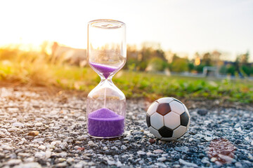 Soccer ball and hourglass symbolizing football time