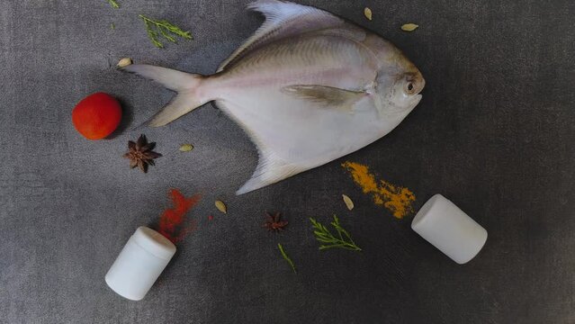 Fresh Silver Pomfret,White Pomfret fish decoratedon a black background.