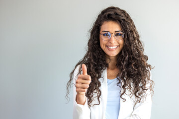 Obraz premium Woman with curly hair wearing casual approving doing positive gesture with hand, thumbs up smiling and happy for success. Winner gesture. 