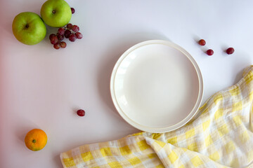 White background, empty plates, yellow cloth, top view
