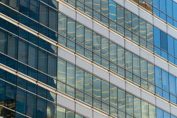 Fototapeta na wymiar sky-high glass windows office building texture background
