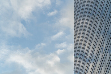 Fototapeta na wymiar sky-high glass windows office building with the sky in the background Leave a blank space
