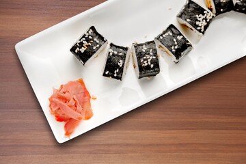 Sushi rolls set. Traditional japanese dish sushi and rolls with fresh salmon, tuna, prawns on rice.  Japanese style dinner