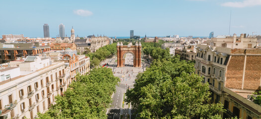 Obraz na płótnie Canvas Aerial view of Barcelona Urban Skyline and The Arc de Triomf or Arco de Triunfo in spanish, a triumphal arch in the city of Barcelona. Sunny day.