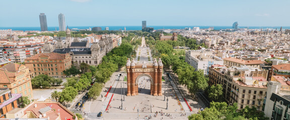 Aerial view of Barcelona Urban Skyline and The Arc de Triomf or Arco de Triunfo in spanish, a triumphal arch in the city of Barcelona. Sunny day. - obrazy, fototapety, plakaty