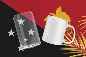 Patriotic can glass and mug mock up on background in colors of national flag. Papua New Guinea
