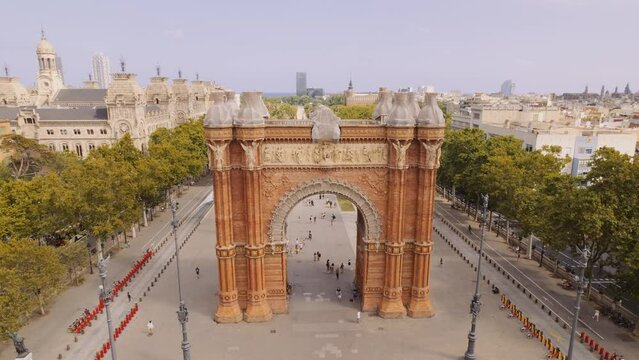 Aerial view of Barcelona Urban Skyline and The Arc de Triomf or Arco de Triunfo in spanish, a triumphal arch in the city of Barcelona. Sunny day. Cinematic 4K