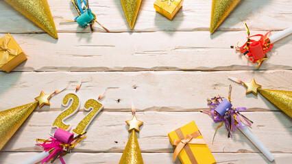  Beautiful colorful card on the background of white boards happy birthday in golden hues copy space. Beautiful ornaments and decorations of gold color festive background. Happy birthday number 27