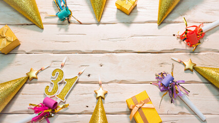  Beautiful colorful card on the background of white boards happy birthday in golden hues copy space. Beautiful ornaments and decorations of gold color festive background. Happy birthday number 31