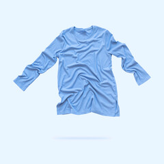 Fototapeta premium Blue flying women's long sleeve sweater isolated on blue background. Fashionable modern female clothing, sportswear, clothing for home and leisure. Cut out object for logo, design, mockup
