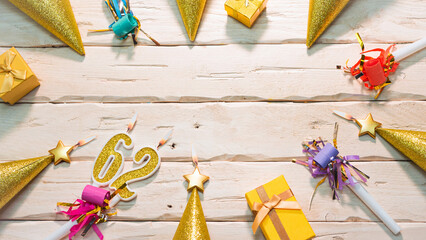 Beautiful colorful card on the background of white boards happy birthday in golden hues copy space. Beautiful ornaments and decorations of gold color festive background. Happy birthday number 62