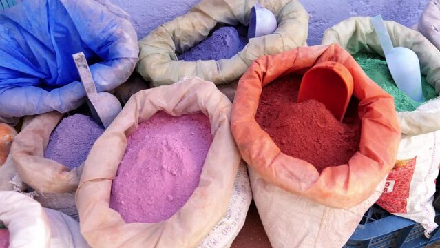 Bags with color dye pigments in the Medina of Chefchaouen (Chaouen), Morocco. Popular travel destination of Morocco. 4k footage.