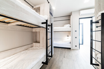 a hostel room with bedrooms, new furniture, beds, and designer renovations - obrazy, fototapety, plakaty