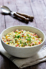 Vegetable salad with crab sticks, dressed with mayonnaise.